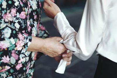 Close-up of woman getting dressed