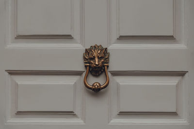 Close up of a lions head door knocker on a front door of a typical british house, uk.