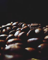 Full frame shot of roasted coffee beans against black background