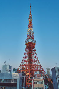 Low angle view of tokyo tower against blue sky