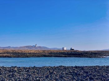 Scenic view of sea against clear blue sky