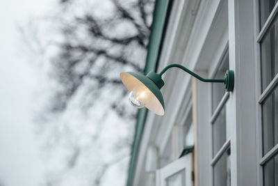 Low angle view of street light against building