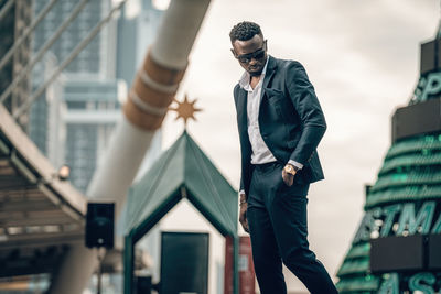 Midsection of man standing by building