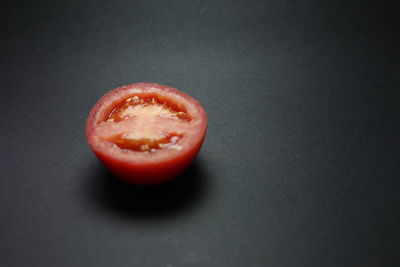 Close-up of red fruit over black background