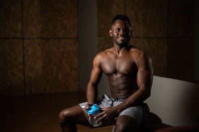 Portrait of young man exercising in gym