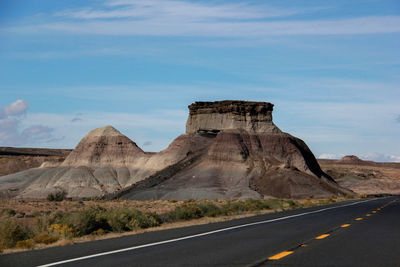Scenic view of road against dramatic sky