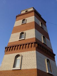 Low angle view of building against clear blue sky