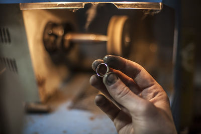 Close-up of hands working on metal