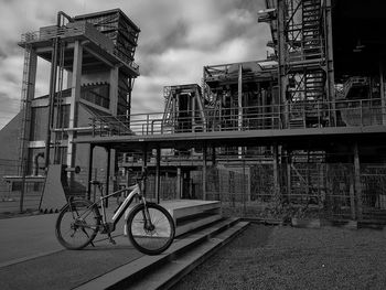 Bicycle on bridge against buildings in city