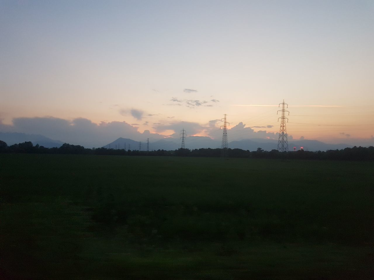 sunset, nature, silhouette, beauty in nature, tranquil scene, tranquility, field, landscape, scenics, sky, no people, outdoors, tree, growth, electricity pylon, grass, day