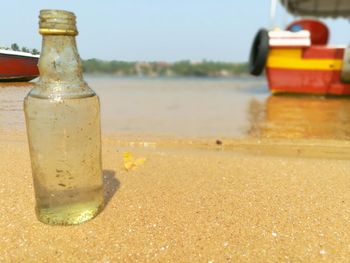 Close-up of water bottle on table at beach