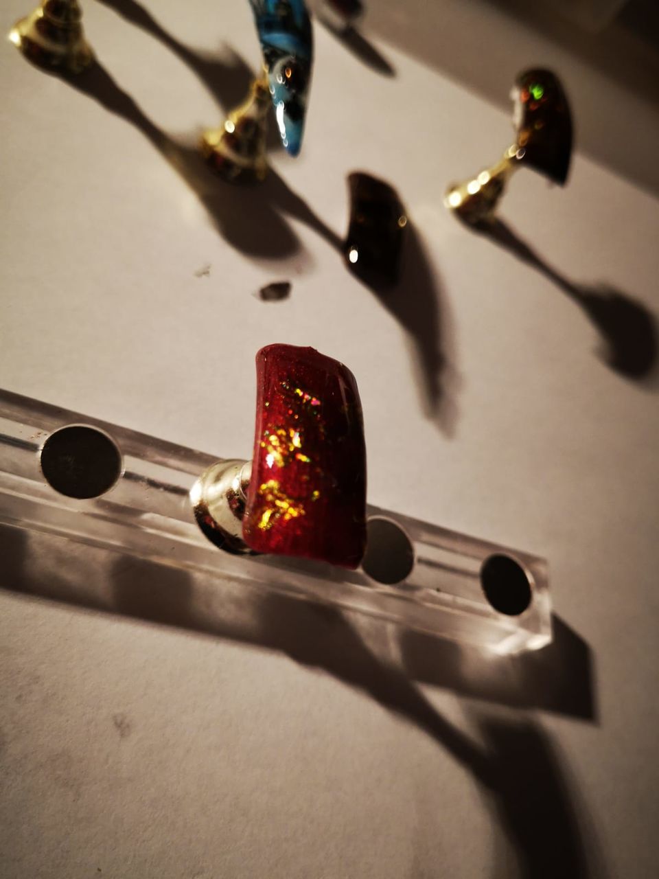 close-up, no people, indoors, high angle view, shadow, table, still life, art and craft, focus on foreground, metal, nature, craft, technology, string instrument, paper, selective focus, music, screwdriver, directly above, tool, electrical equipment