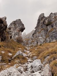 Low angle view of rock formations against sky