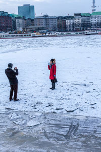 Person standing on snow covered water