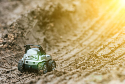 Close-up of toy car on dirt road