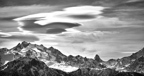 Scenic view of mountains against cloudy sky