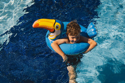 Rear view of woman swimming in sea