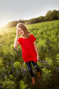 Full length of young woman standing on field