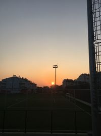 Silhouette buildings against clear sky during sunset