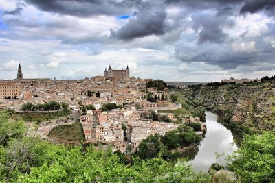 High angle shot of townscape against clouds