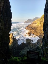 Scenic view of sea and mountains against sky