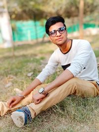 Young man wearing sunglasses on field