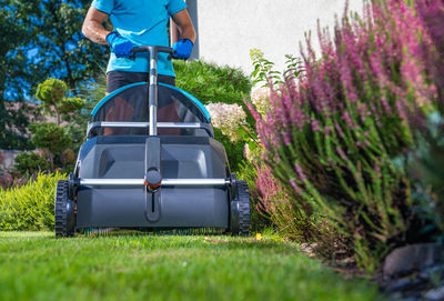 Low section of man standing on grass