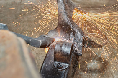 Close-up of worker working on metal