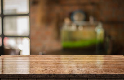 Close-up of wooden table against building