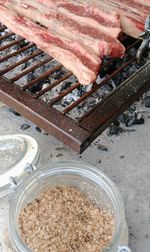 High angle view of meat on barbecue grill