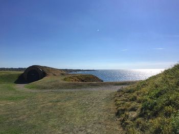 Scenic view of sea against blue sky