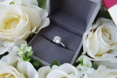 Close-up of wedding ring on roses