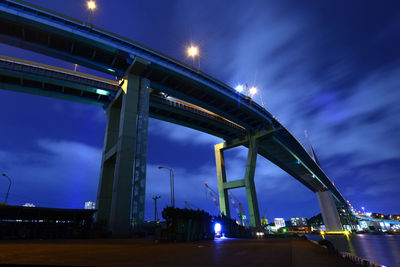 Low angle view of illuminated bridge against sky at night