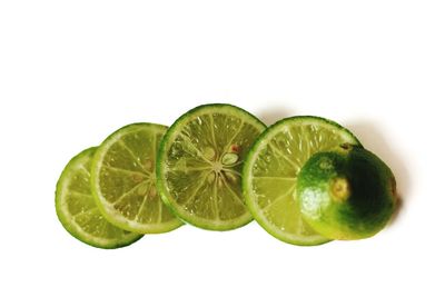 Close-up of lemon slice over white background