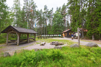 Built structure on field against trees and houses