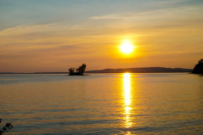 Scenic view of lake against romantic sky at sunset