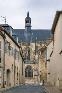 Street amidst buildings in town against sky