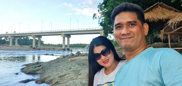 Portrait of smiling young woman at bridge