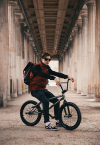 Man riding bicycle in corridor