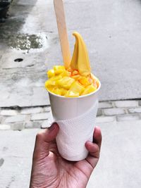 Midsection of person holding ice cream