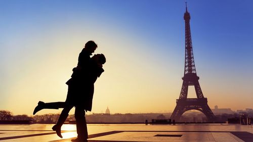 Silhouette of couple against eiffel tower