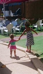 Full length rear view of siblings playing in house