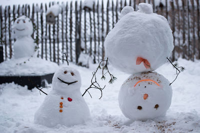 Snowman on field during winter