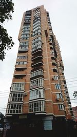 Low angle view of office building against sky