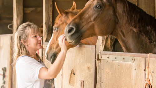 Side view of woman with horse