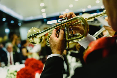 Midsection of man playing musical instrument