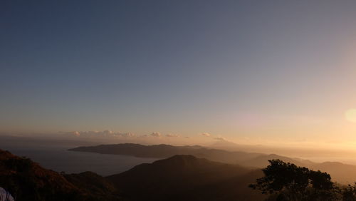 Scenic view of silhouette mountains against clear sky