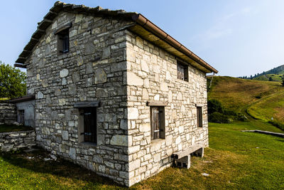 Stone shelter among the green meadows on the mountains above revine lago treviso veneto italy