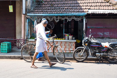 Man with bicycle on street