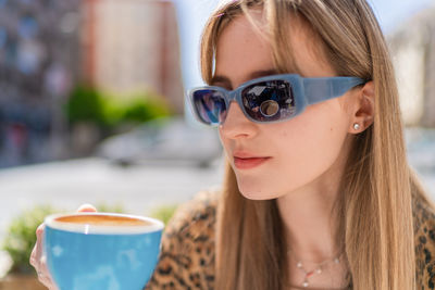 Portrait of young woman wearing sunglasses